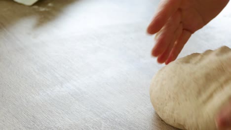 female hands kneading bread