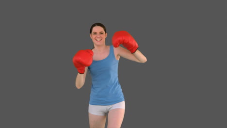 pretty young model with boxing gloves punching