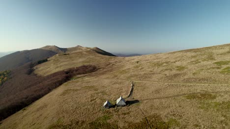 Aerial-view-of-two-mountain-shelters-in-the-Bieszczady-National-Park-in-Poland