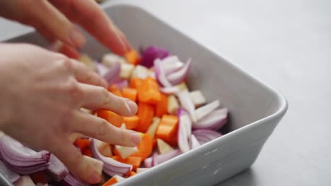 crop woman mixing vegetables in pan