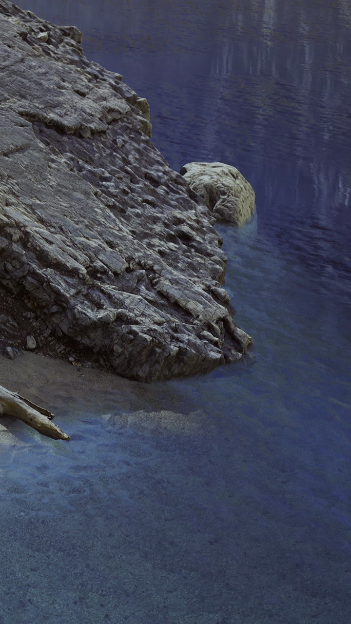 Rugged shoreline embraces tranquil waters under twilight hues