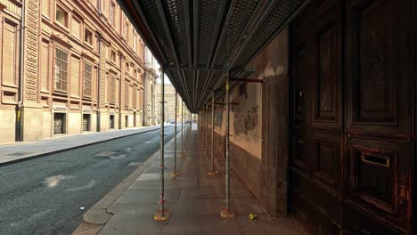 scaffolding and graffiti along a turin street