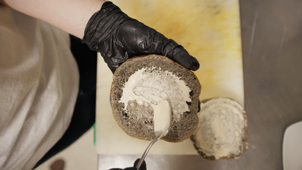 Chef Spreading The Special Mayonnaise On The Bottom Of The Gourmet Burger