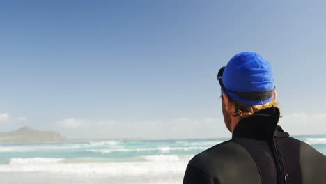 male surfer standing in the beach