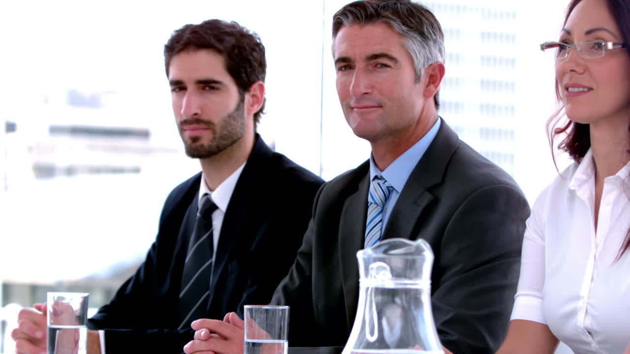 Business people sitting on interview panel
