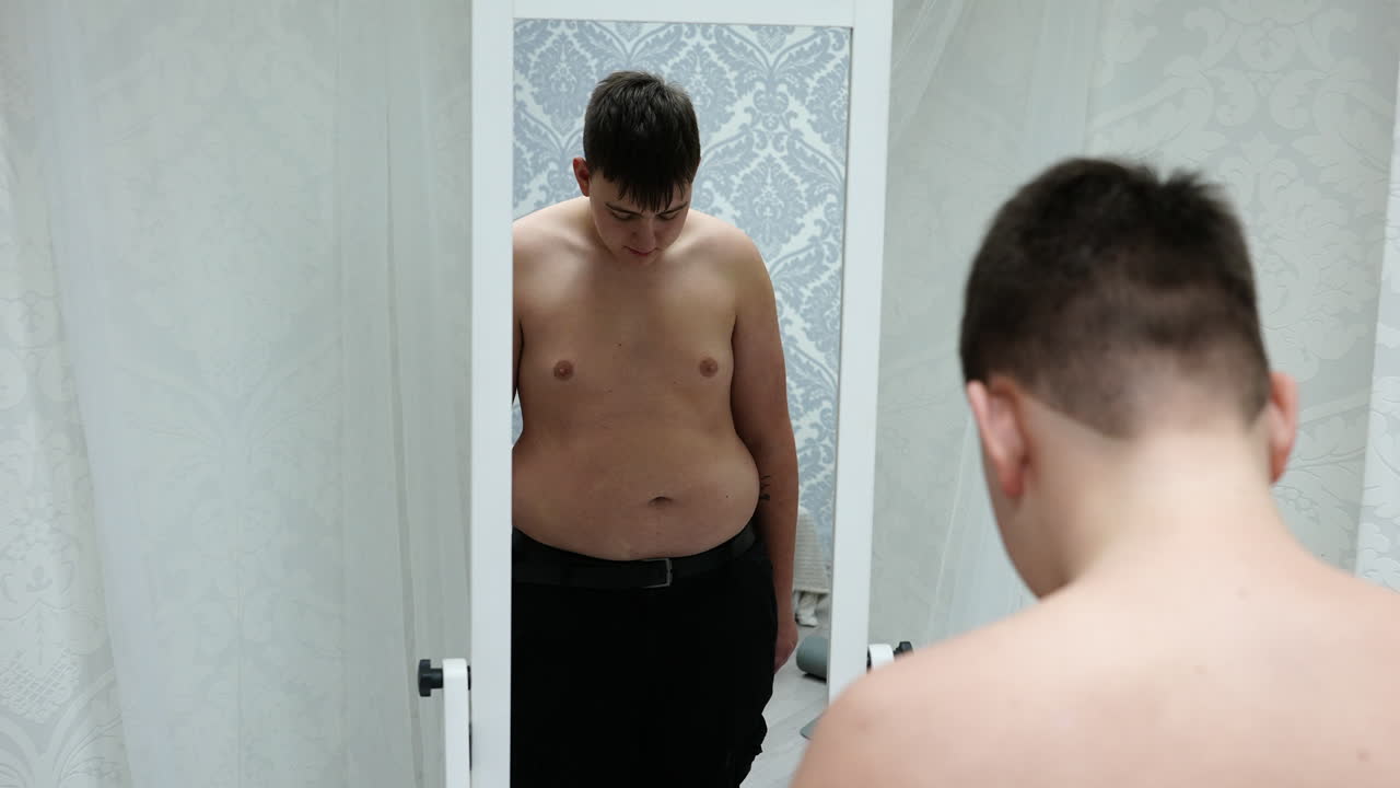 Young Fat Man Looking At His Mirror Reflection And Shaking His Belly Free  Stock Video Footage Download Clips