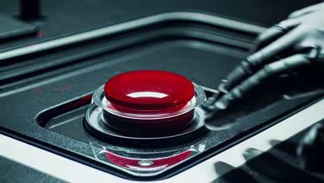 big red button with transparent glass protection cover is ready to be pushed, activating a self destruction protocol in a dark control panel, causing a global disaster