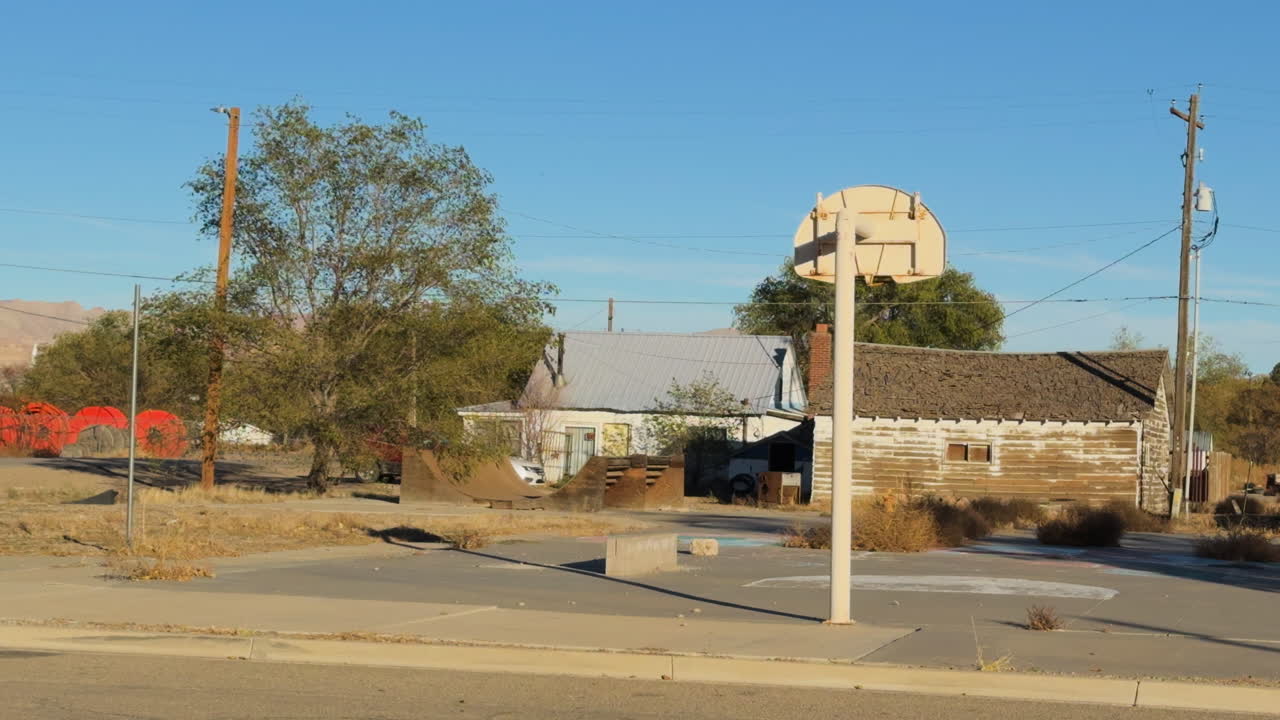A roadside court with a basketball hoop.