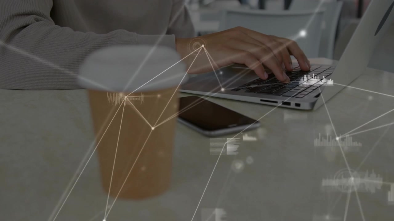 Person Working on Laptop with Digital Data Overlay