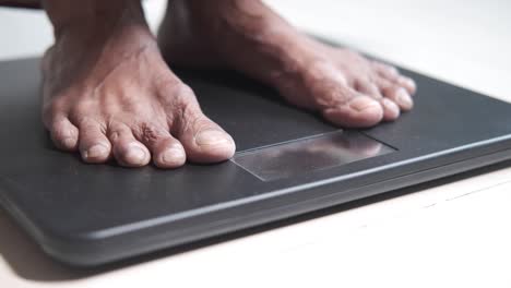 person standing on a weighing scale