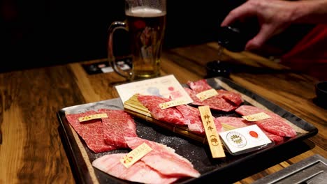 hands revealing variety of packaged steaks