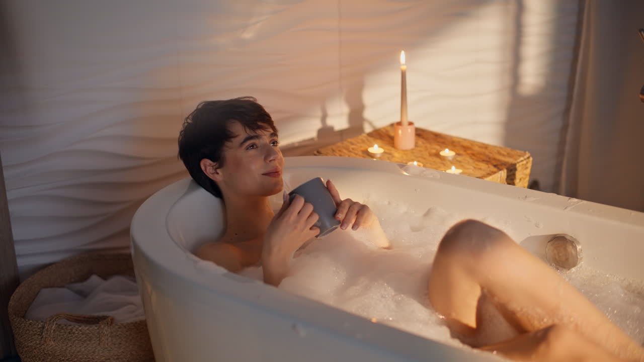 Dreamy model bathing evening warming hot beverage cup closeup. Rich lady bath