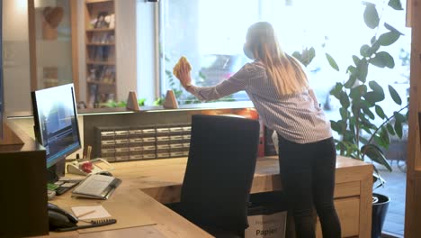 receptionist - office employee disinfects the protective screens in the reception area - covid 19 tourism footage