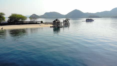 sandy beach and jetty on the island of kelor on sunny summer day