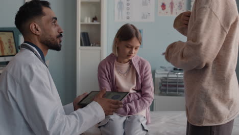 doctor explaining diagnosis to child patient and mother