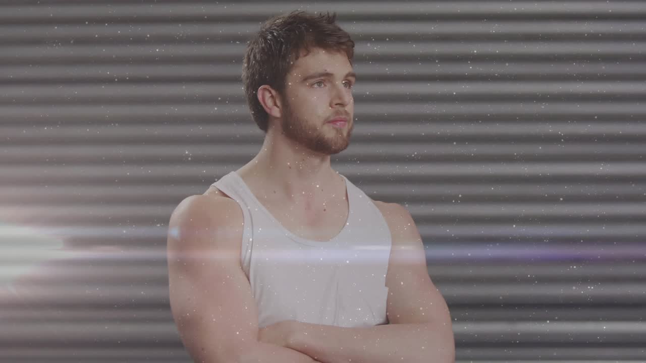 Fitness male white tank, arms folded, adjusting gaze smiling as flare sweeping rollup dust promo