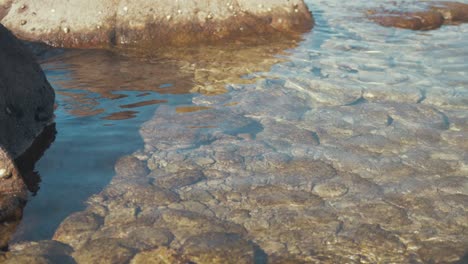 Shallow-rocky-seaside-shore-rippling-waves