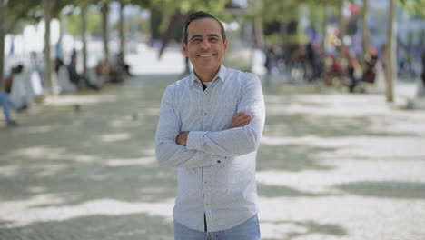 handsome hispanic man smiling at camera outdoor