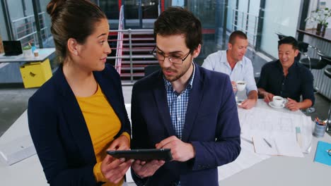 ejecutivos de negocios discutiendo sobre una tableta digital