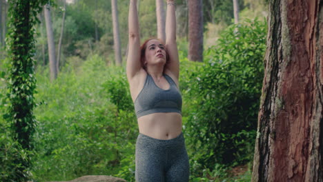 girl practices yoga in a forest moutain move