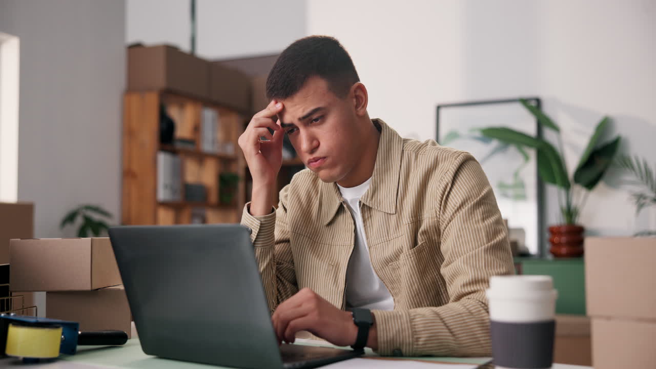 Stressed Man Working on Laptop