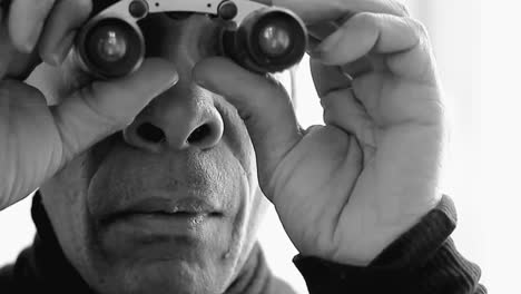 man looking through binoculars with white background with people stock video stock footage