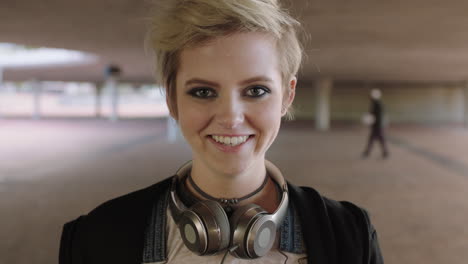 portrait of smiling trendy woman student wearing headphones happy alternative