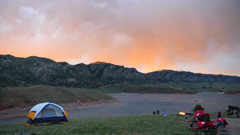 campers walk to lake at sunset holding hands