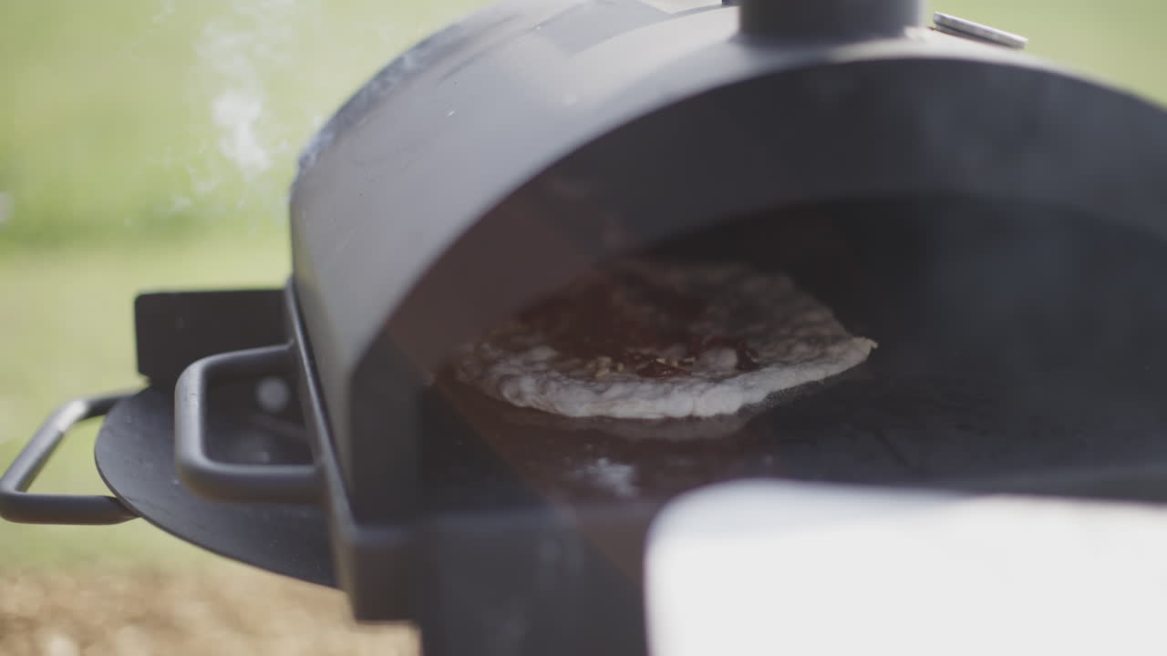 Pizza Baking in Outdoor Wood-Fired Oven