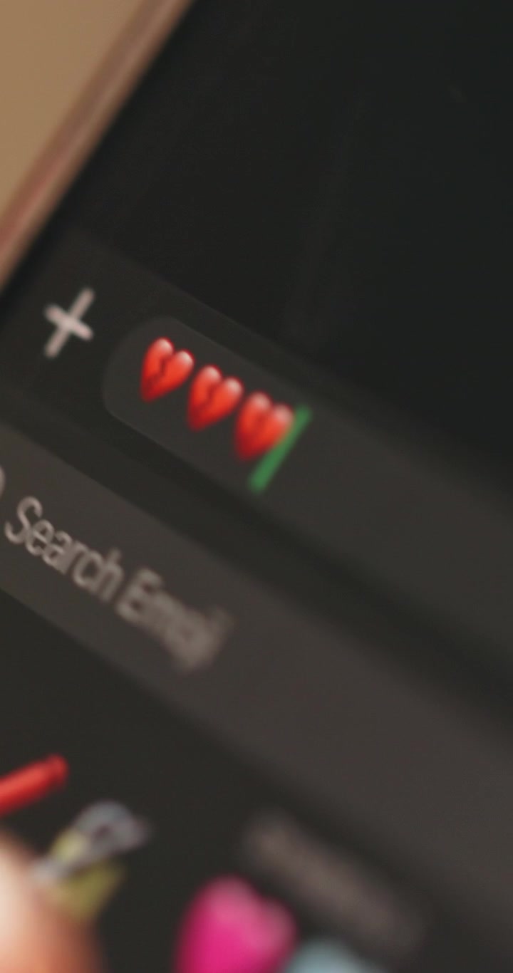Person Typing Broken Heart Emojis on Smartphone Screen