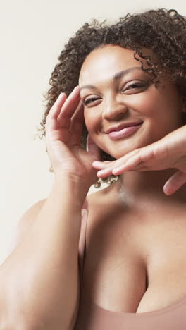 vertical video: smiling plus size woman posing confidently, embracing body positivity