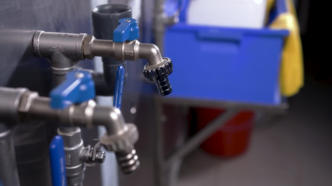 A person in a waterworks takes a sample to check the quality of the water
