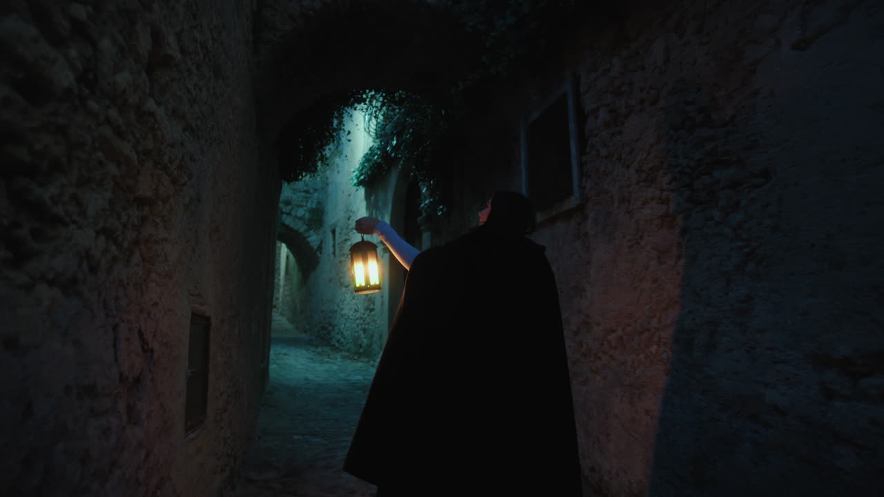 Mysterious Woman Walks Through the Streets of the Village at Night with Lantern