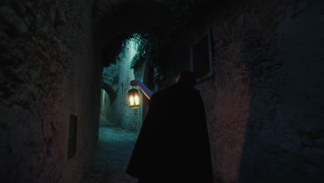 mysterious woman walks through the streets of the village at night with lantern