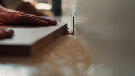 cabinetmaker in joinery using heavy machinery, close up