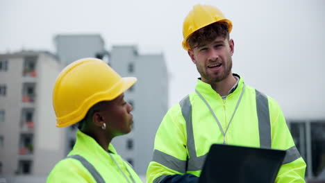 construction workers discussing plans on a building site