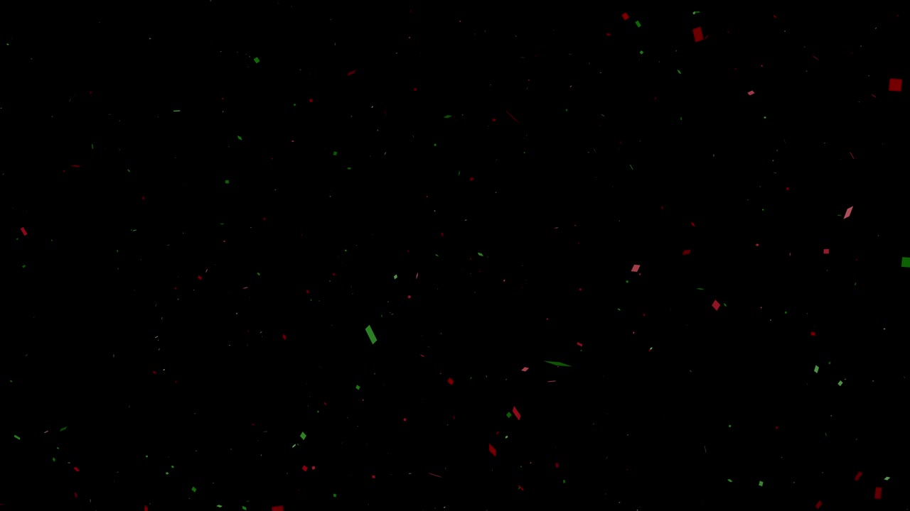 papel rojo y verde disparador o confeti en un fondo negro para celebraciones, fiestas, navidad, año nuevo y felicitaciones.