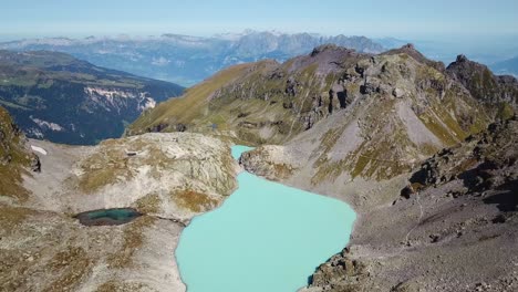stunning aerial view of a turquoise alpine lake in the swiss alps