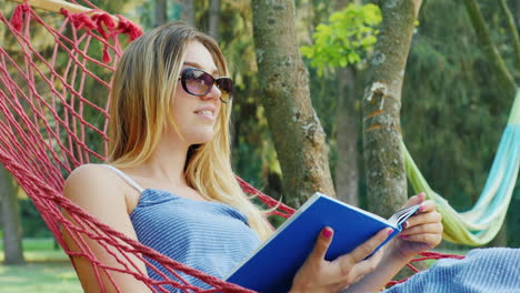 Attractive-woman-rests-in-a-hammock-on-a-summer-day