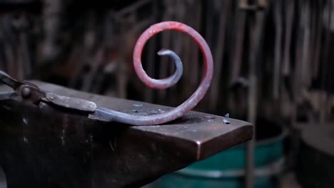 blacksmith shaping the molten metal with hammer 4k