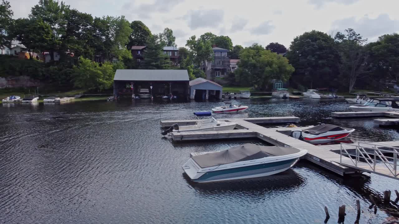 2 boats glide through a tranquil marina track shot