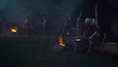medieval blacksmith at campfire