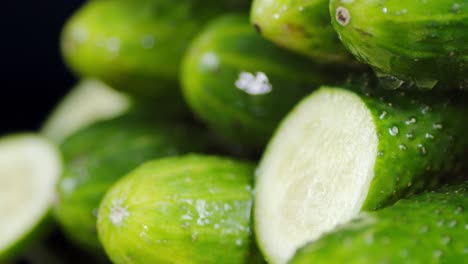 fresh cucumbers with drops of water slowly rotate.