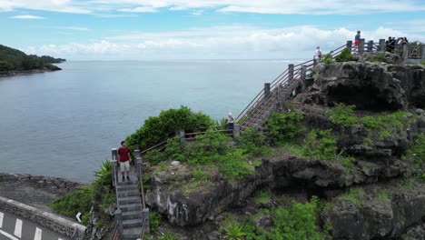 tourists visiting sightseeing spot on peninsula with ocean view in mauritius