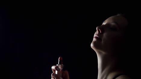 woman applying perfume