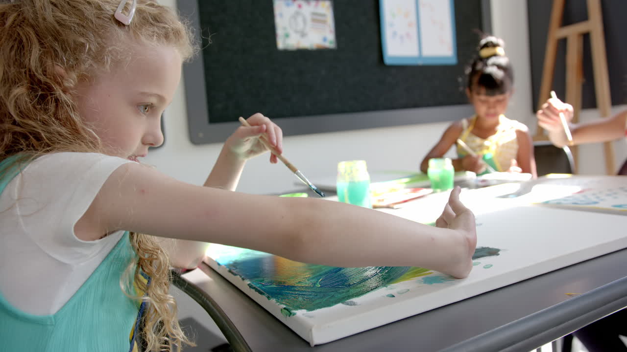 In school, children painting on canvas in classroom, enjoying creative activity