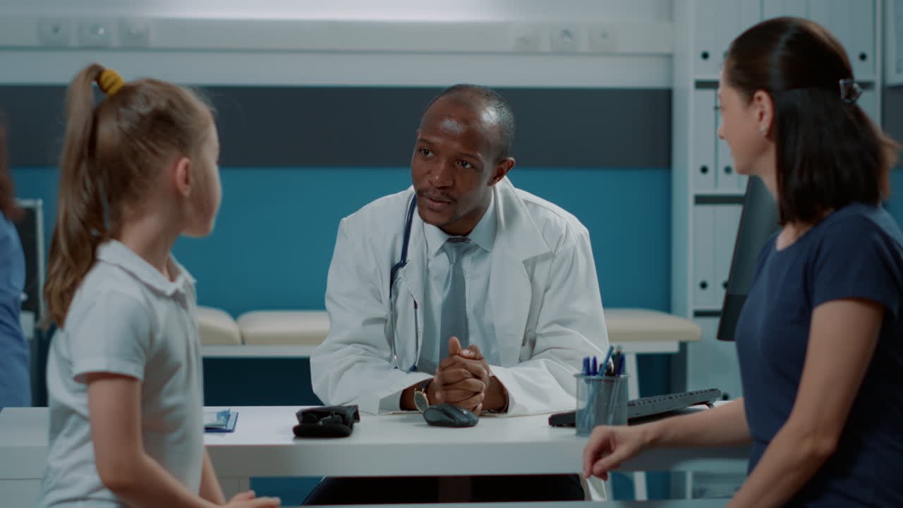 Doctor Consults with Child Patient and Mother