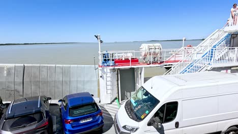 cars and van on ferry crossing water