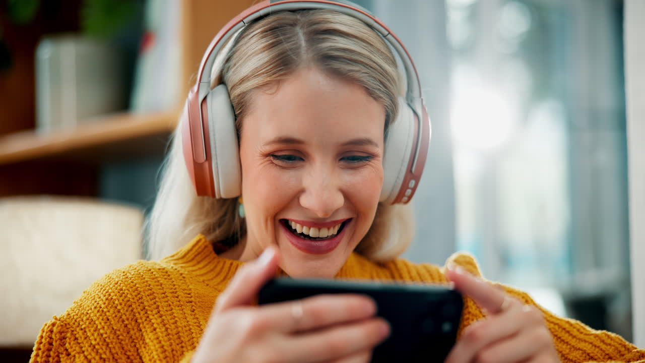 Woman playing game on her phone with headphones