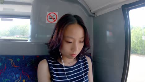 Girl-listening-music-on-a-bus-4k